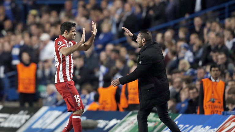 Diego Costa (L) celebrates with Atletico Madrid's coach Diego Simeone