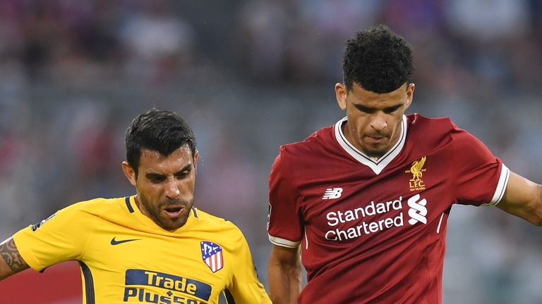 Dominic Solanke and Augusto (L) vie for the ball