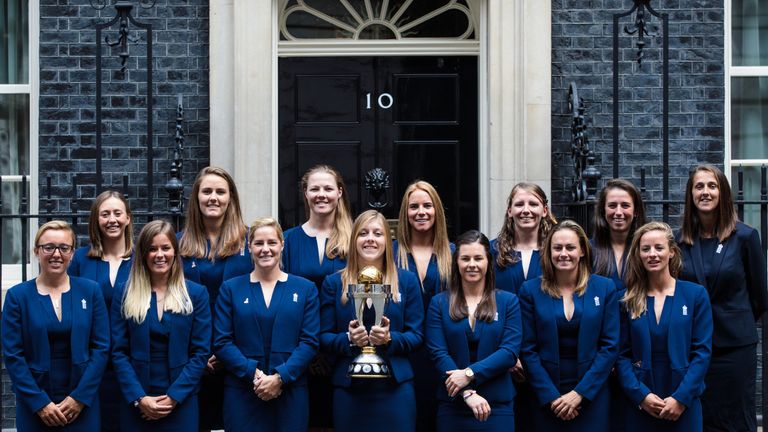 England women's captain Heather Knight (C) holds the ICC Women's World Cup Cricket trophy outside No 10
