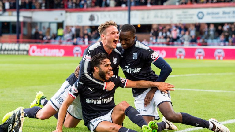 Dundee's Faissal El Bakhtaoui (seated) savours his goal in the Tayside derby