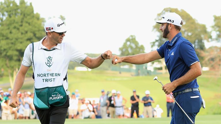 WESTBURY, NY - AUGUST 27:  Dustin Johnson of the United States celebrates with caddie Austin Johnson after putting on the 18th green during the final round