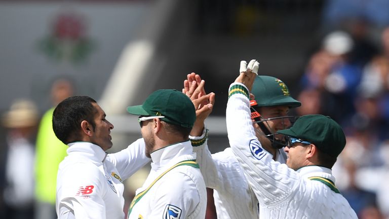 South Africa's Keshav Maharaj (L) celebrates with team-mates after dismissing Alastair Cook 