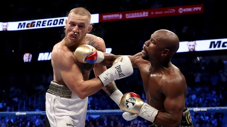 Floyd Mayweather lands a heavy shot on Conor McGregor