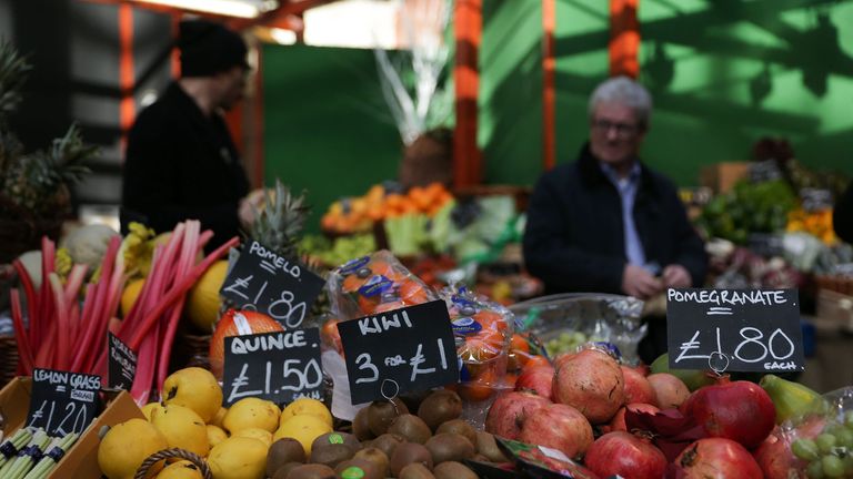 Signs display the price in pounds sterling of fruit and vegetables at a street market in southeast London, on February 14, 2017.
British annual inflation p