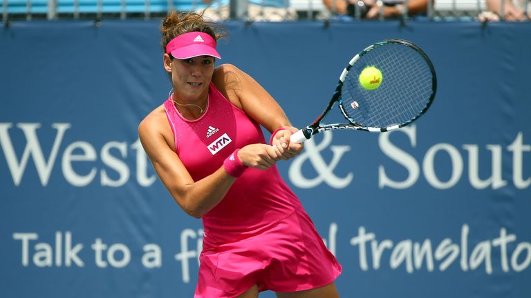 CINCINNATI, OH - AUGUST 12:  Garbine Muguruza of Spain hits a return during her match against Annika Beck of Germany at the Western & Southern Open at the 