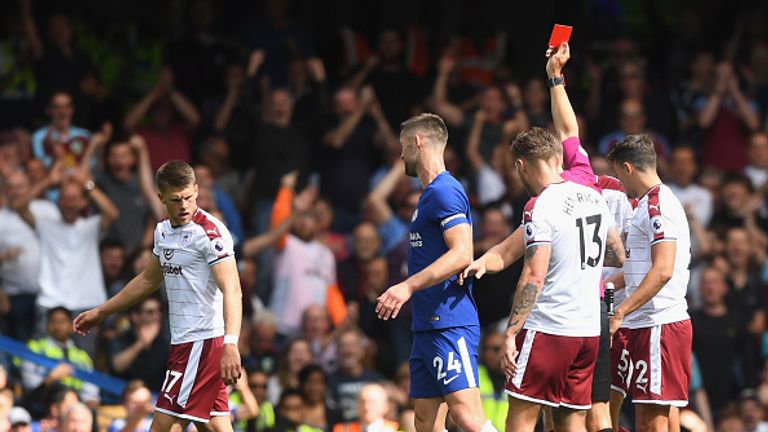LONDON, ENGLAND - AUGUST 12:  Gary Cahill of Chelsea is sent off by referee Craig Pawson after a challenge on Steven Defour of Southampton (on floor) durin