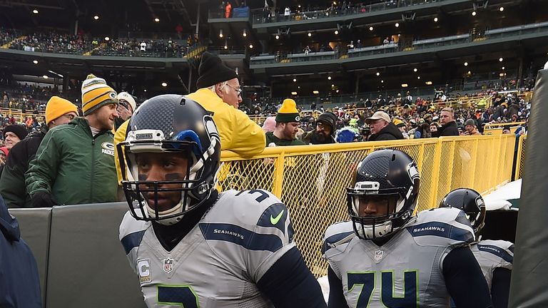 GREEN BAY, WI - DECEMBER 11: Russell Wilson #3 and George Fant #74 of the Seattle Seahawks take the field prior to a game against the Green Bay Packers at 