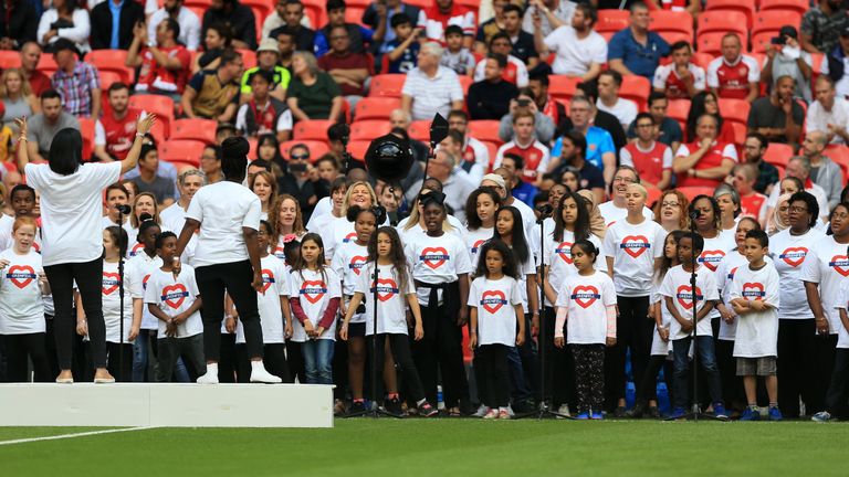 A choir performs in memory of the victims of Grenfell Tower during the Community Shield at Wembley, London.
