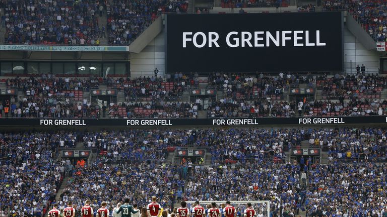 The Arsenal team lines up during a minute of silence for the victims of the Grenfell disaster before the start of the English FA Community Shield football 
