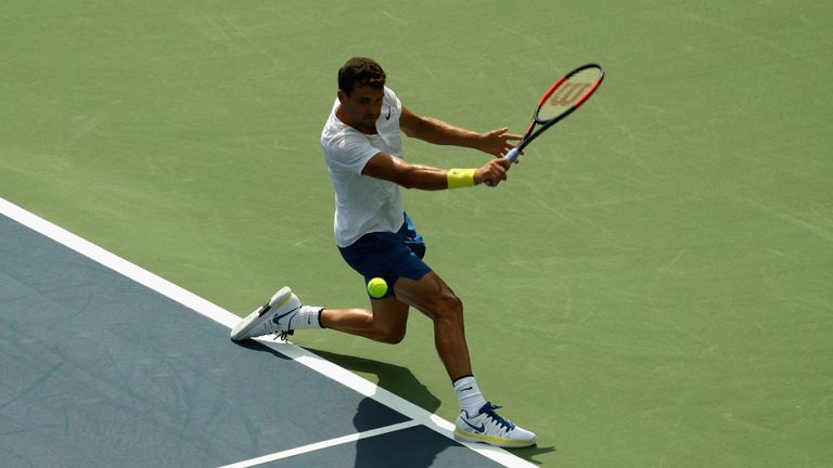 MASON, OH - AUGUST 16:  Grigor Dimitrov of Bulgaria returns a shot to Feliciano Lopez of Spain during Day 5 of the Western & Southern Open at the Linder Fa