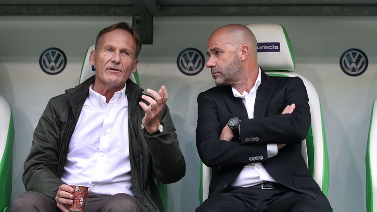 WOLFSBURG, GERMANY - AUGUST 19: Chairman Hans-Joachim Watzke (L) of Dortmund chats with head coach Peter Bosz (R) of Dortmund 