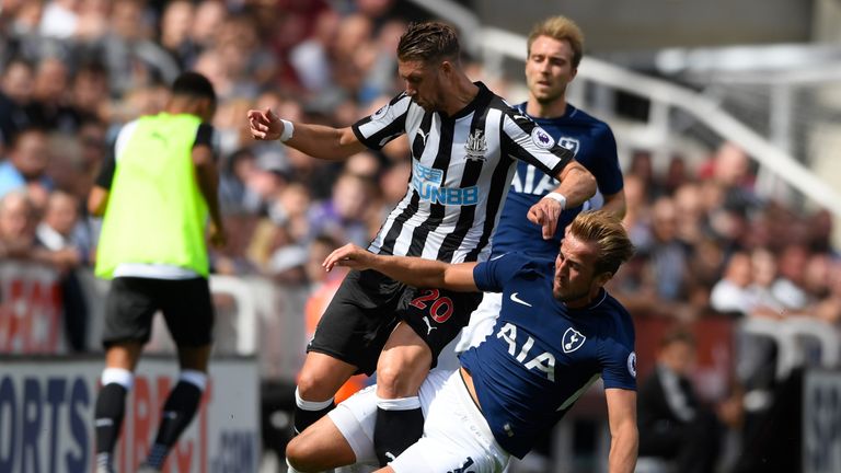NEWCASTLE UPON TYNE, ENGLAND - AUGUST 13:  Harry Kane of Tottenham Hotspur fouls Florian Lejeune of Newcastle United and recives a yellow card during the P