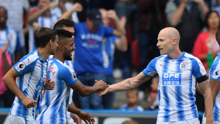 Huddersfield's Aaron Mooy (R) celebrates with teammates  after giving his side the lead over Newcastle 