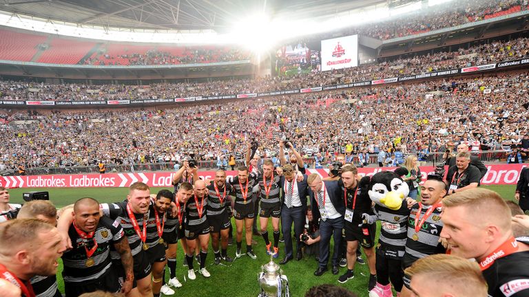 Hull FC celebrate and dance around the trophy