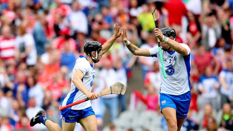 Waterford's Jamie Barron celebrates scoring his sides fourth goal with Maurice Shanahan.
