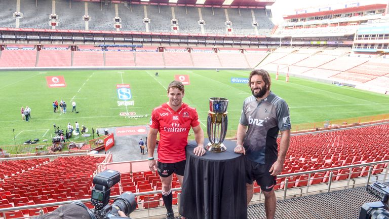 Lions captain Jaco Kriel (L) and Crusaders captain  Sam Whitelock pose with the Super Rugby trophy.