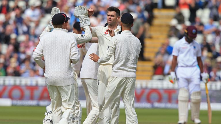 James Anderson (C) celebrates with team-mates after taking the wicket of Kyle Hope 