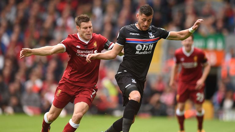 James Milner (L) vies with Crystal Palace defender Joel Ward