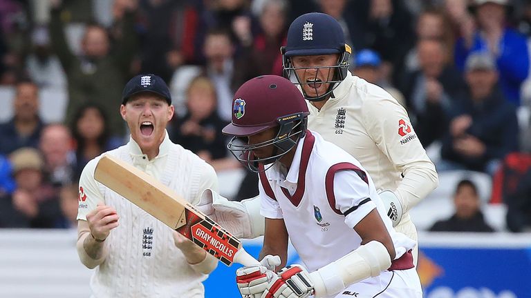 Ben Stokes (L) and Jonny Bairstow (R) react after taking the wicket of Indies' Kraigg Brathwaite (C)