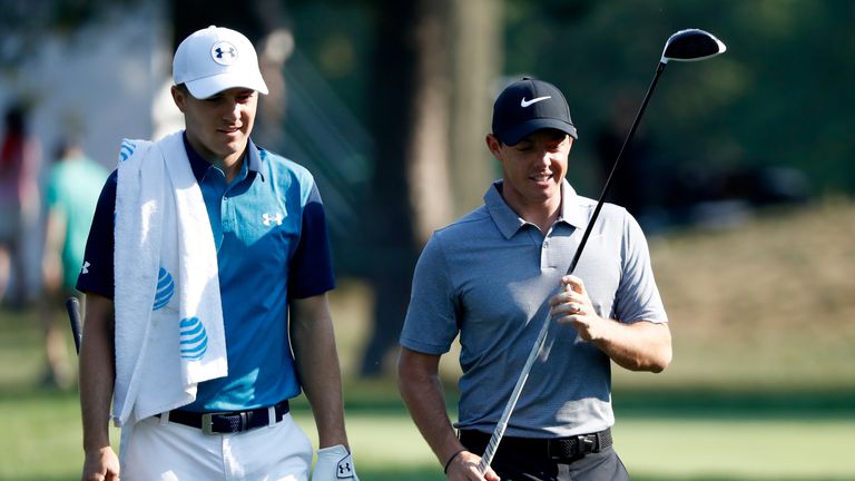 Jordan Spieth and Rory McIlroy of Northern Ireland walk off the tee during the first round of the WGC-Bridgestone Invitational