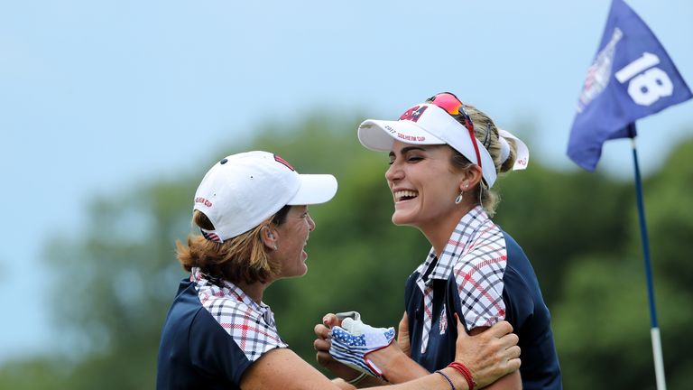 Juli Inkster (L) the United States team captain embraces Lexi Thompson on the 18th green