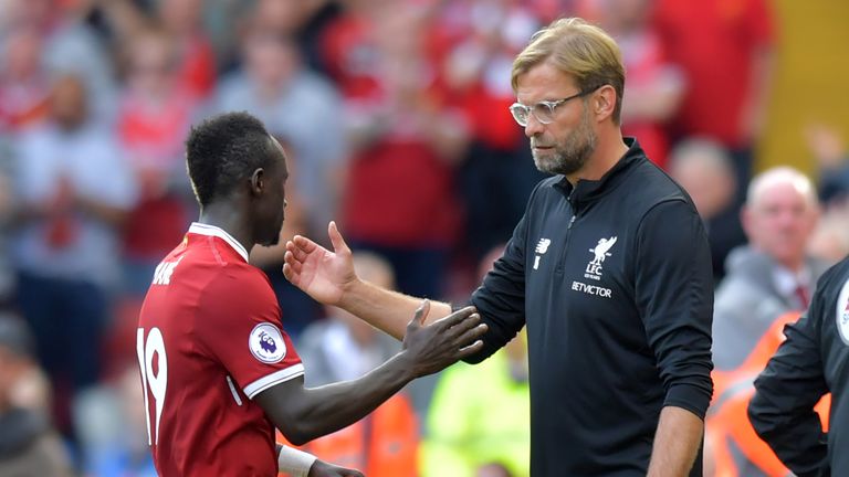Liverpool boss Jurgen Klopp shakes hands with Sadio Mane (L) as he leaves the pitch, substituted during the Premier League match v Arsenal