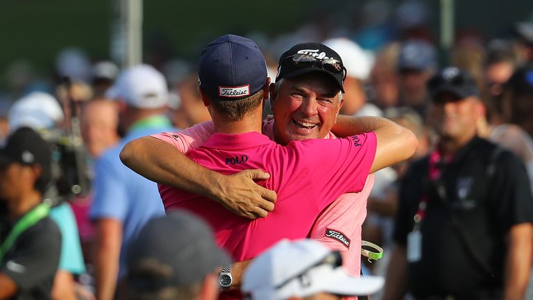 Thomas hugs his father Mike after clinching victory