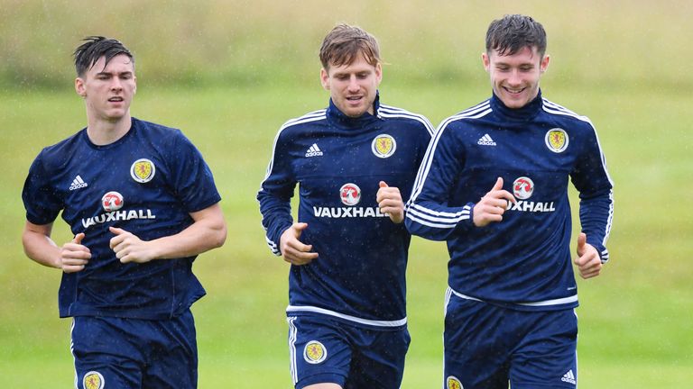 Kieran Tierney, Stuart Armstrong and Anthony Ralston take part in training in the rain at Mar Hall on Monday