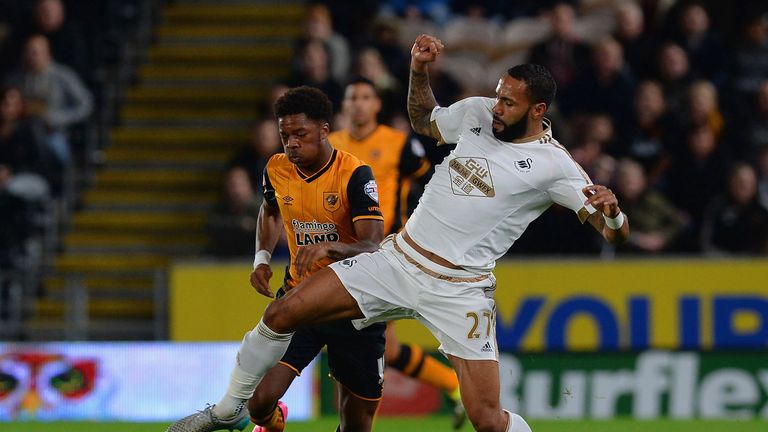 Kyle Bartley of Swansea City tackles Chuba Akpom of Hull City during the Capital One Cup third round match 