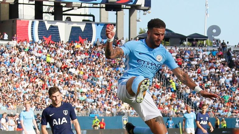 Kyle Walker of Manchester City jumps over goaltender Hugo Lloris of Tottenham in Nashville