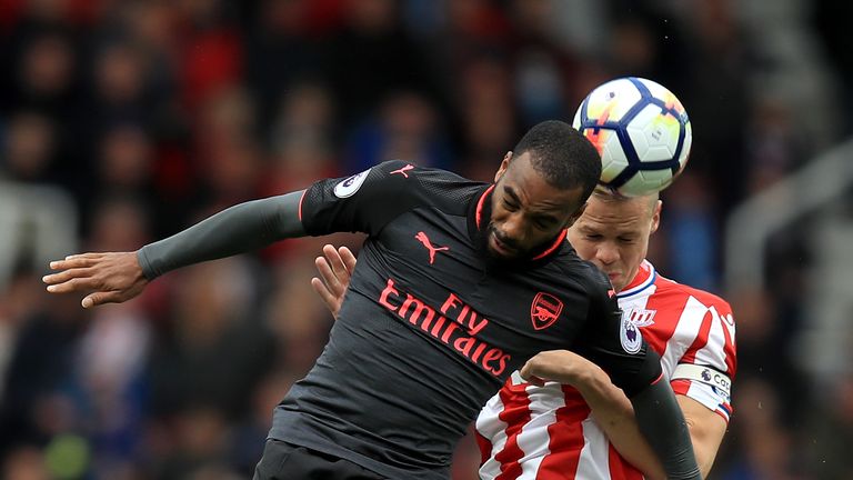 Arsenal's Alexandre Lacazette (left) and Stoke City's Ryan Shawcross battle for the ball during the Premier League match at the bet365 Stadium, Stoke.