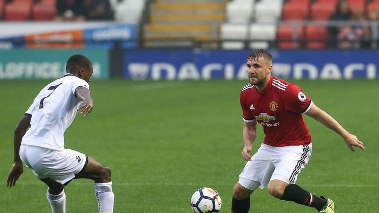 Luke Shaw looks to take on Jordan Garrick during the Premier League 2 match between Manchester United U23s and Swansea City U23s