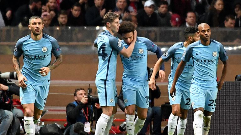 Manchester City's German midfielder Leroy Sane (C) celebrates with teammates after scoring a goal during the UEFA Champions League round of 16 match