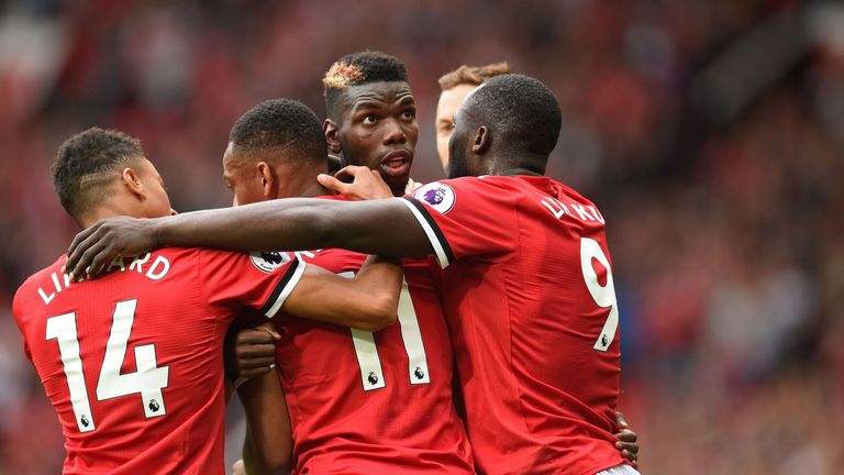 Manchester United's French midfielder Paul Pogba (C) celebrates with teammates after scoring their fourth goal