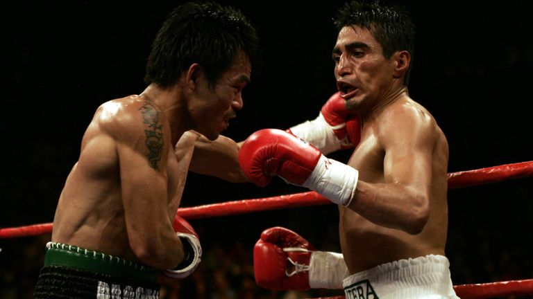 LAS VEGAS - MARCH 19:   Manny Pacquiao of the Philippines hits Erik Morales of Mexico with a left hook during the World Super Featherweight Championship at