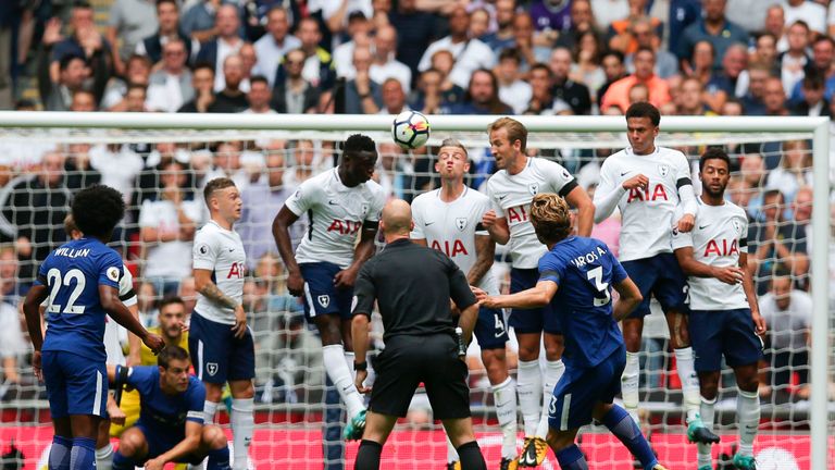 Chelsea's Marcos Alonso (R) curls a free kick over the Tottenham defensive wall to score the opening goal during the Premier League clash at Wembley