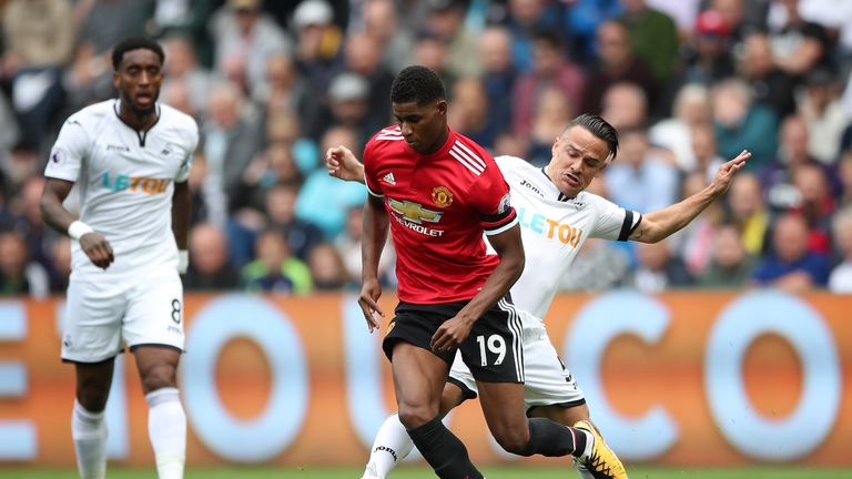Marcus Rashford and Roque Mesa battle for the ball at the Liberty Stadium