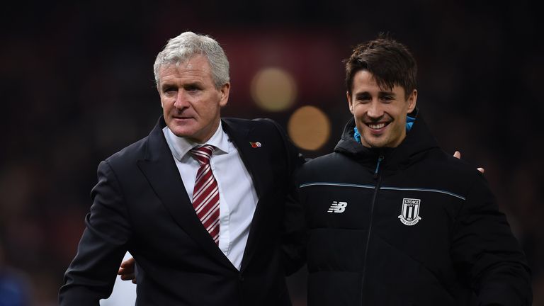 Stoke City's Welsh manager Mark Hughes (L) celebrates with Stoke City's Spanish striker Bojan Krkic as they leave the pitch