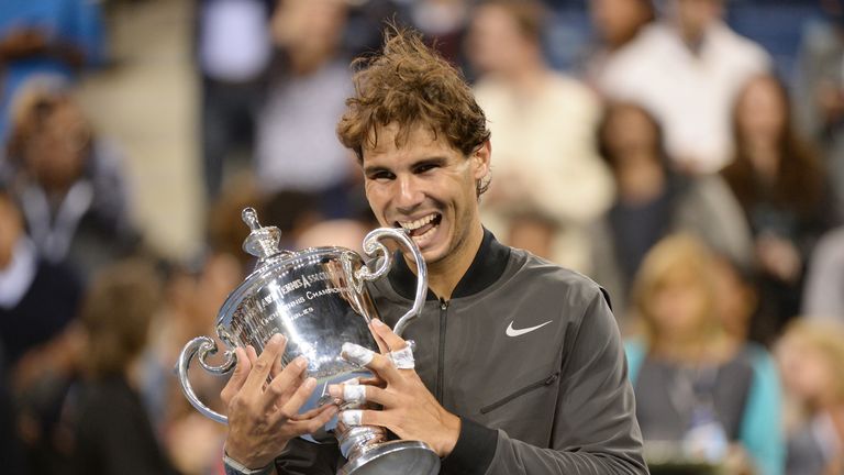 Rafael Nadal of Spain holds the trophy as he celebrates his win over Novak Djokovic of Serbia during their 2013 US Open men's singles final match at the US