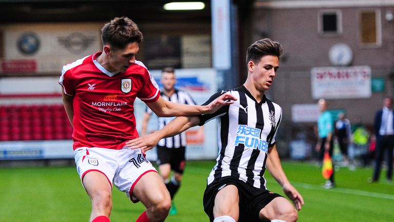 CREWE, ENGLAND - AUGUST 29:Victor Fernandez of Newcastle United (66) controls the ball whilst being pursued by Callum Ainley of Crewe Alexandra (14) during