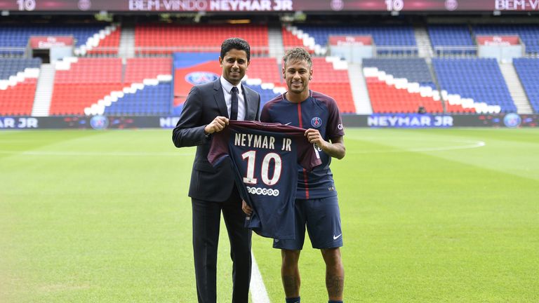 Neymar poses next to PSG President Nasser Al-Khelaifi after a press conference at Parc des Prince
