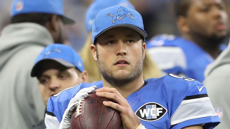 Matthew Stafford #9 of the Detroit Lions warms up on the sidelines with a glove on his right hand during the second quarter