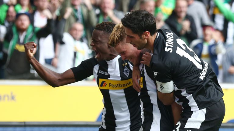 MOENCHENGLADBACH, GERMANY - AUGUST 20: Nico Elvedi of Moenchengladbach (center) celebrates having 