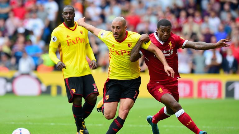WATFORD, ENGLAND - AUGUST 12:  Nordin Amrabat of Watford and Georginio Wijnaldum of Liverpool battle for possession during the Premier League match between