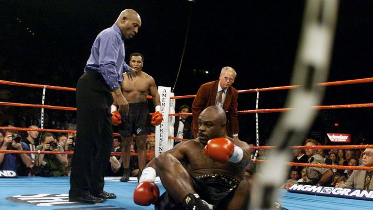 LAS VEGAS, UNITED STATES:  Referee Richard Steele (L) motions Mike Tyson (C) to a neutral corner after the former heavyweight champion hit former cruiserwe