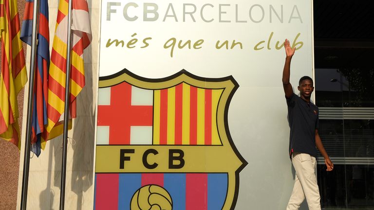 Barcelona's new player Ousmane Dembele poses outside the Camp Nou stadium in Barcelona, prior to signing his new contract with the Catalan club, on August 