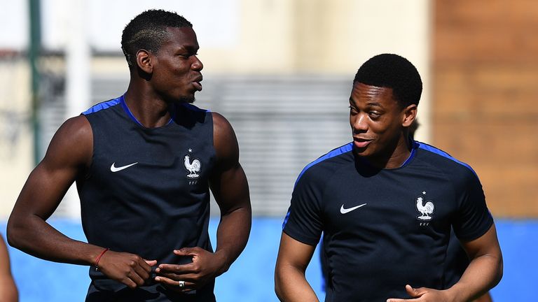 France's midfielder Paul Pogba (L) speaks with France's forward Anthony Martial dduring a training session on the eve of the team's Euro 2016 semi-final 