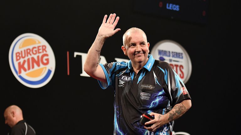 Darts' Legend Phil Taylor waves to the crowd after his victory during Day 1 of t