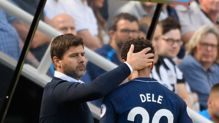  Dele Alli embraces with Mauricio Pochettino