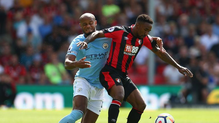 Jermain Defoe and Vincent Kompany in action during the Premier League match at the Vitality Stadium